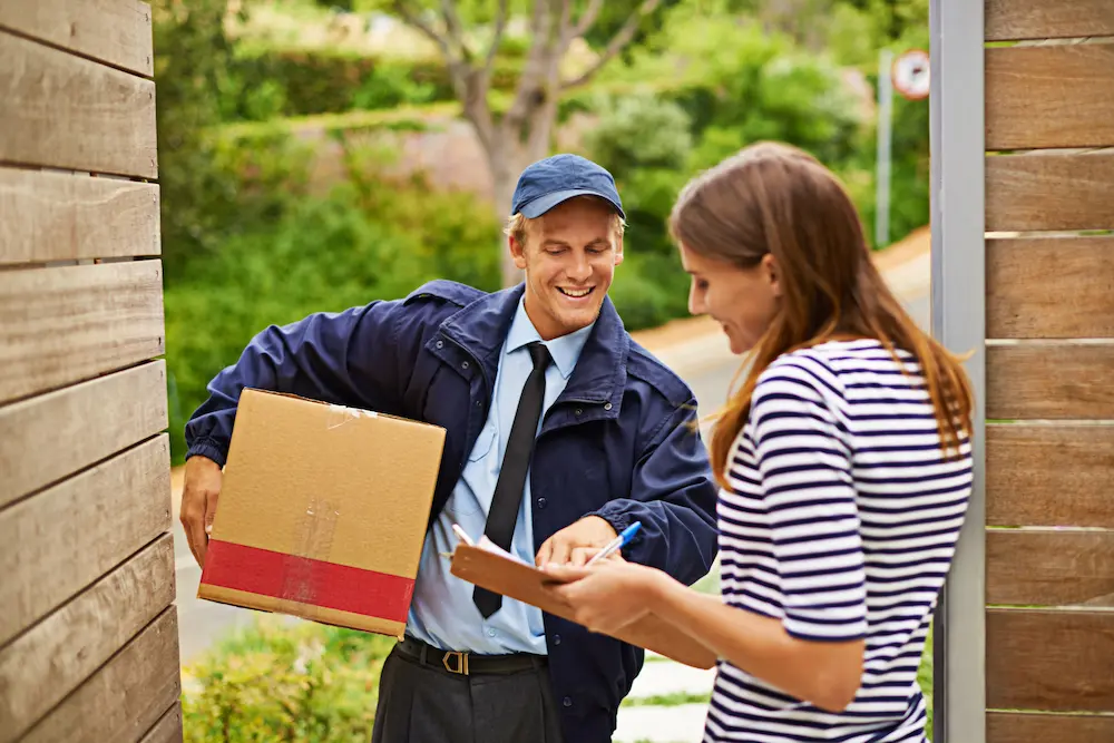 Courier Delivering a Package to a Home Doorstep in Canada