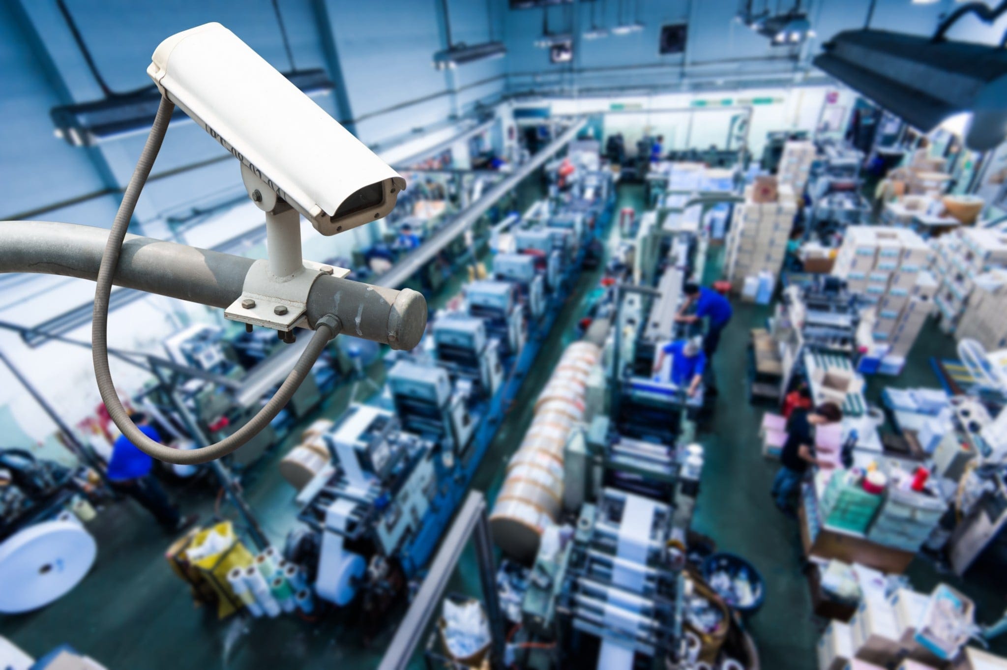 CCTV monitoring in a busy factory production area.