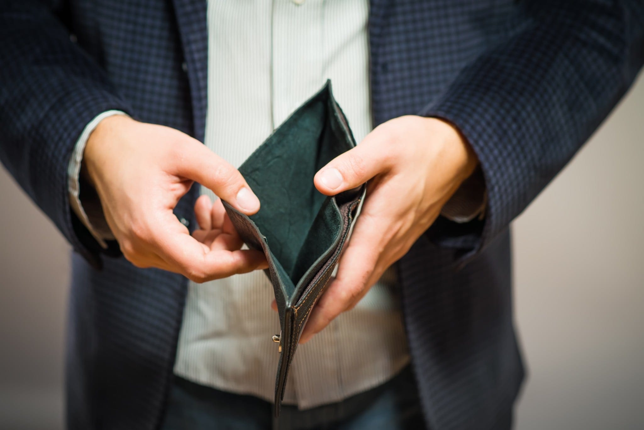 Person holding an empty wallet open